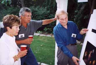 Stanley Wulc (right) shows his still lifes to Ellin and Joe Paquette (left)